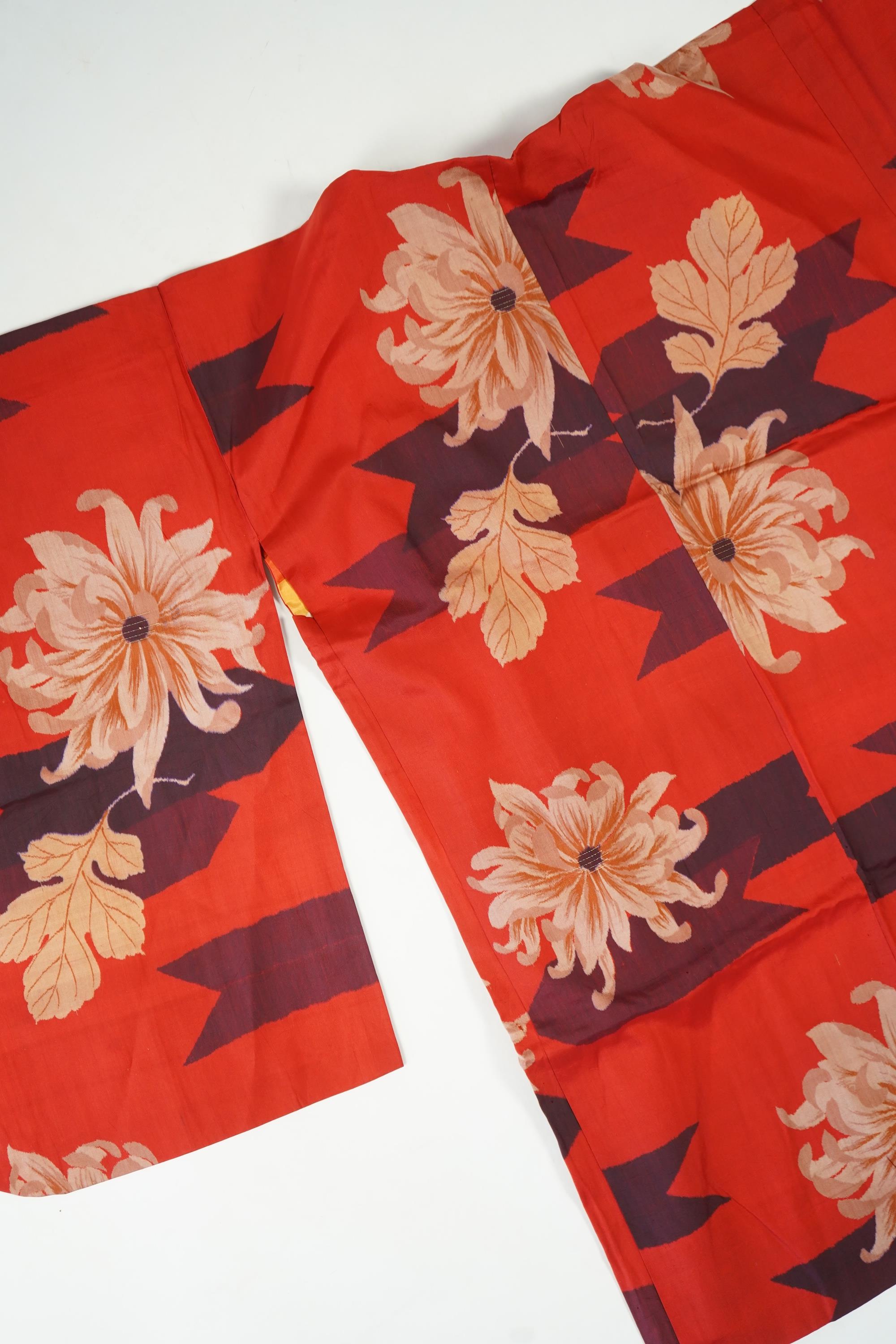 Three Japanese mid 20th century ‘Haori’ printed silk jackets. One red with brightly coloured lining and rust brown floral silk lining. All with large kimono sleeves. Grey patterned Haori, 79cm long., Condition - good